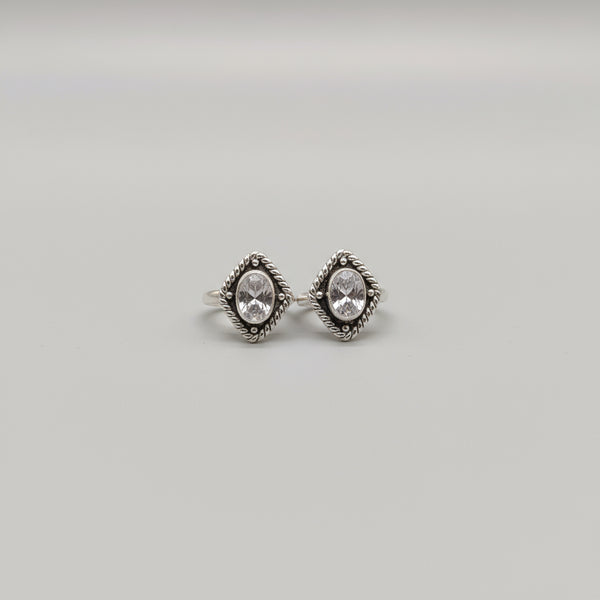 A pair of silver toe rings with a shimmering surface