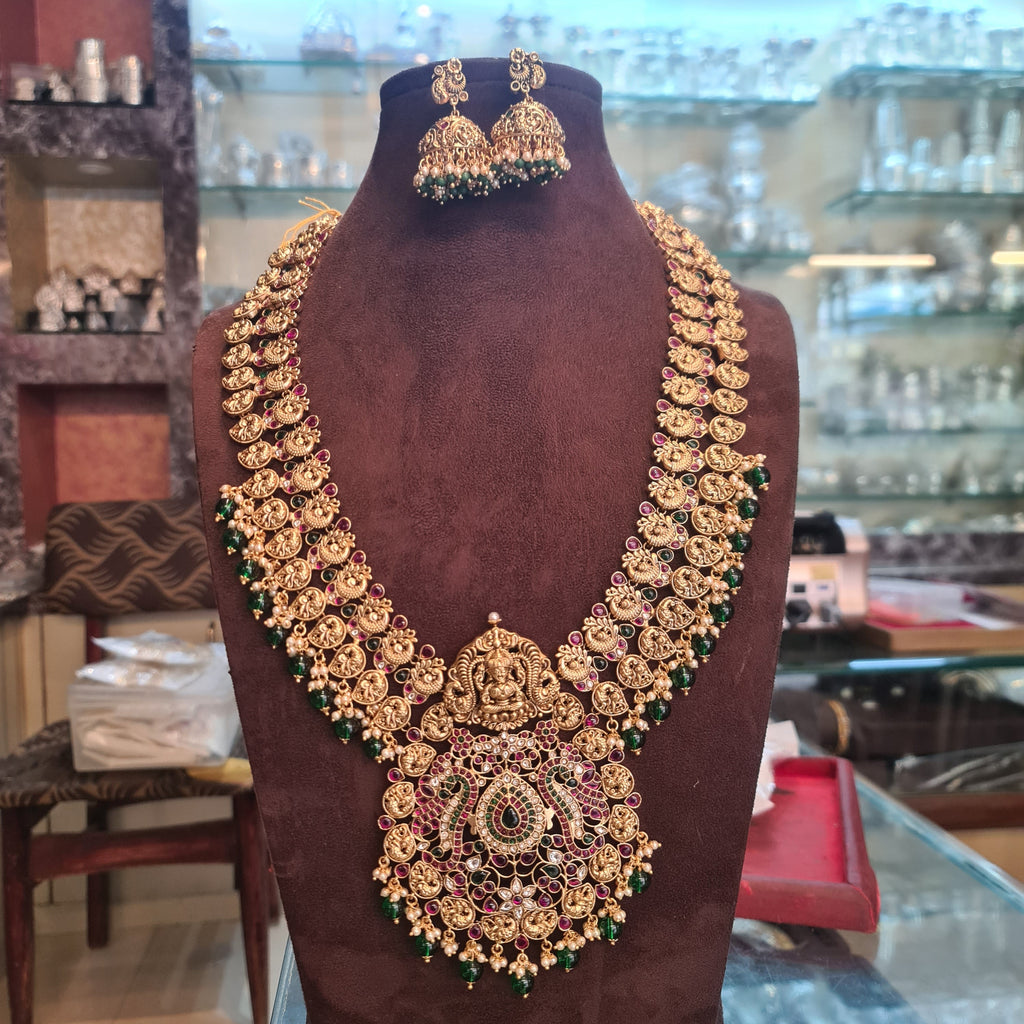 Lakshmi Temple Haram Long Necklace Set with Jhumka Earrings - Antique Gold with Ruby and Emerald Beads