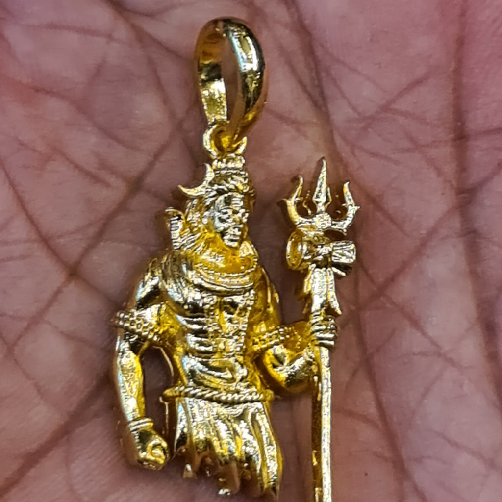 Panchaloham Lord Shiva pendant held in hand showing gold finish, trishul and intricate deity detailing