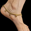 A gold-colored Slim Panchloha Pattilu anklet on a person's ankle, featuring small ornamental pendants.