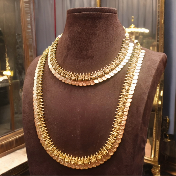 Gold necklace on a brown mannequin bust with a reflective background
