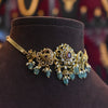 Ornate gold and blue gemstone necklace on a dark brown mannequin bust.