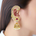 Gold earrings with pearls and gemstones worn by a person