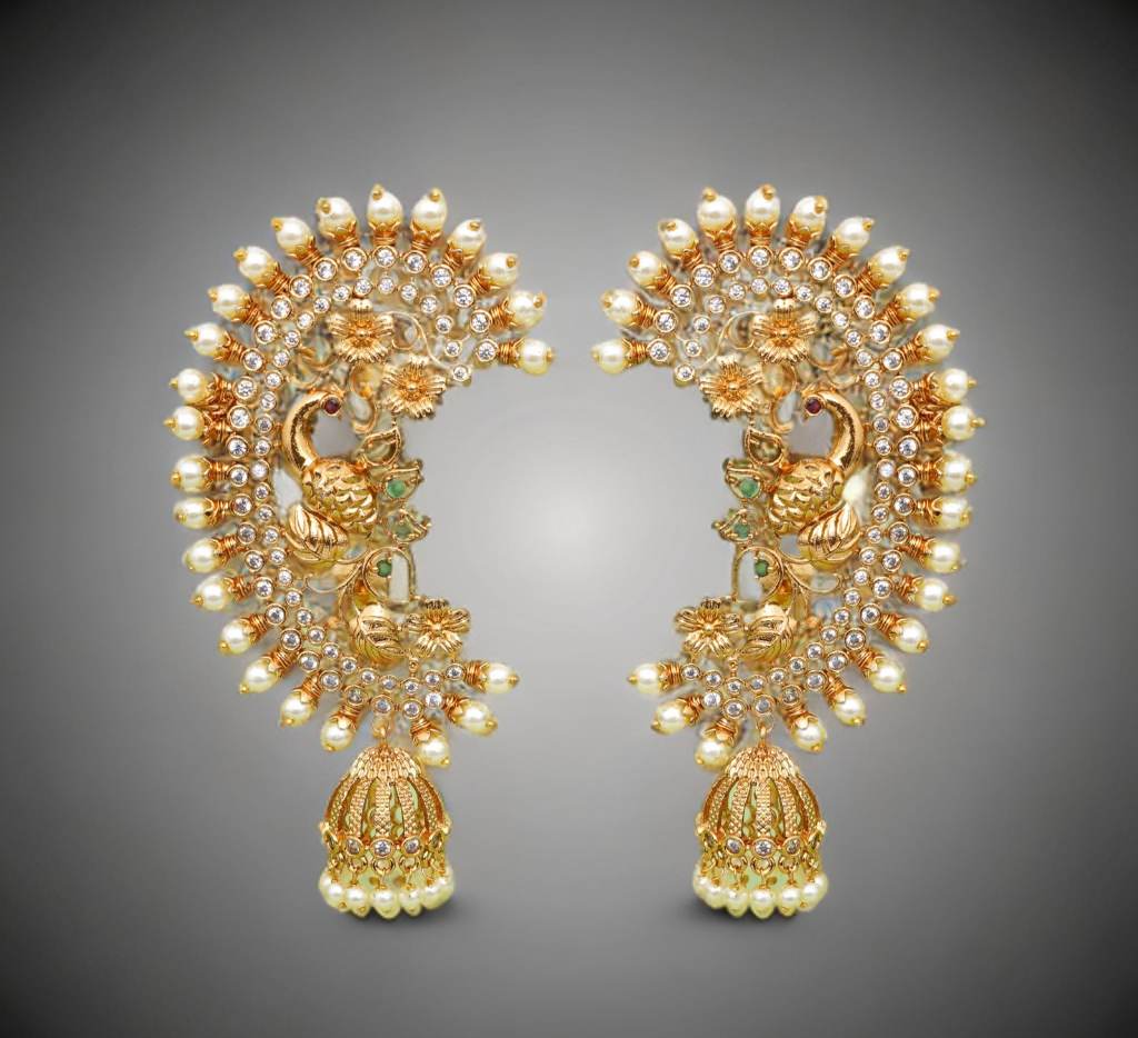 Pair of ornate gold earrings with pearls on a gray background
