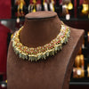 Decorative necklace on a brown velvet stand with blurred jewelry store background