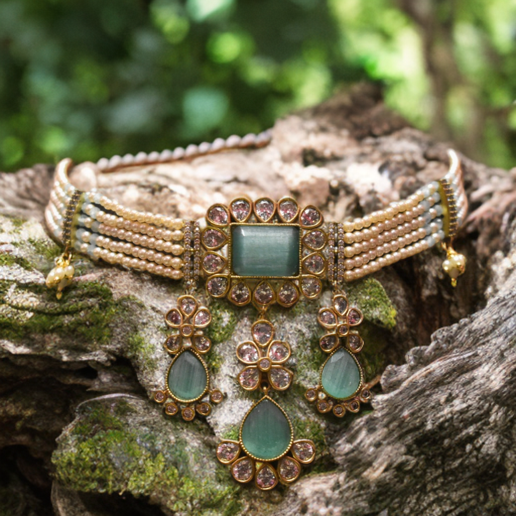 Ornate necklace with green stones on a textured surface