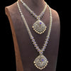 Ornate necklace with purple gemstones on a mannequin bust against a black background