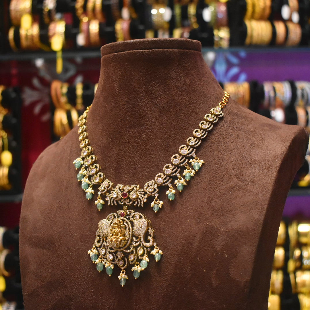 Decorative necklace on a brown mannequin with a blurred jewelry store background