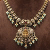 Ornate necklace with gold and gemstone details on a brown background