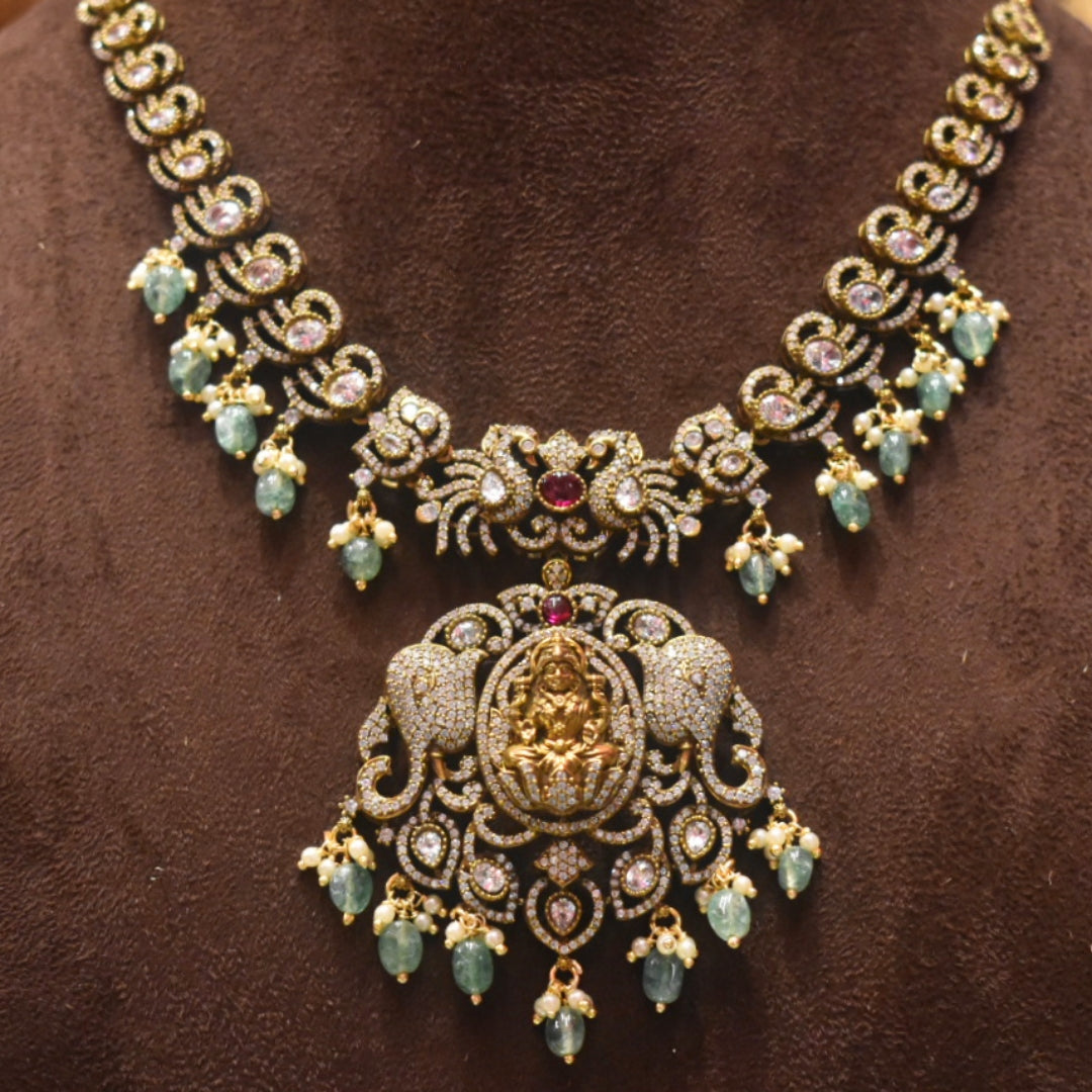 Ornate necklace with gold and gemstone details on a brown background
