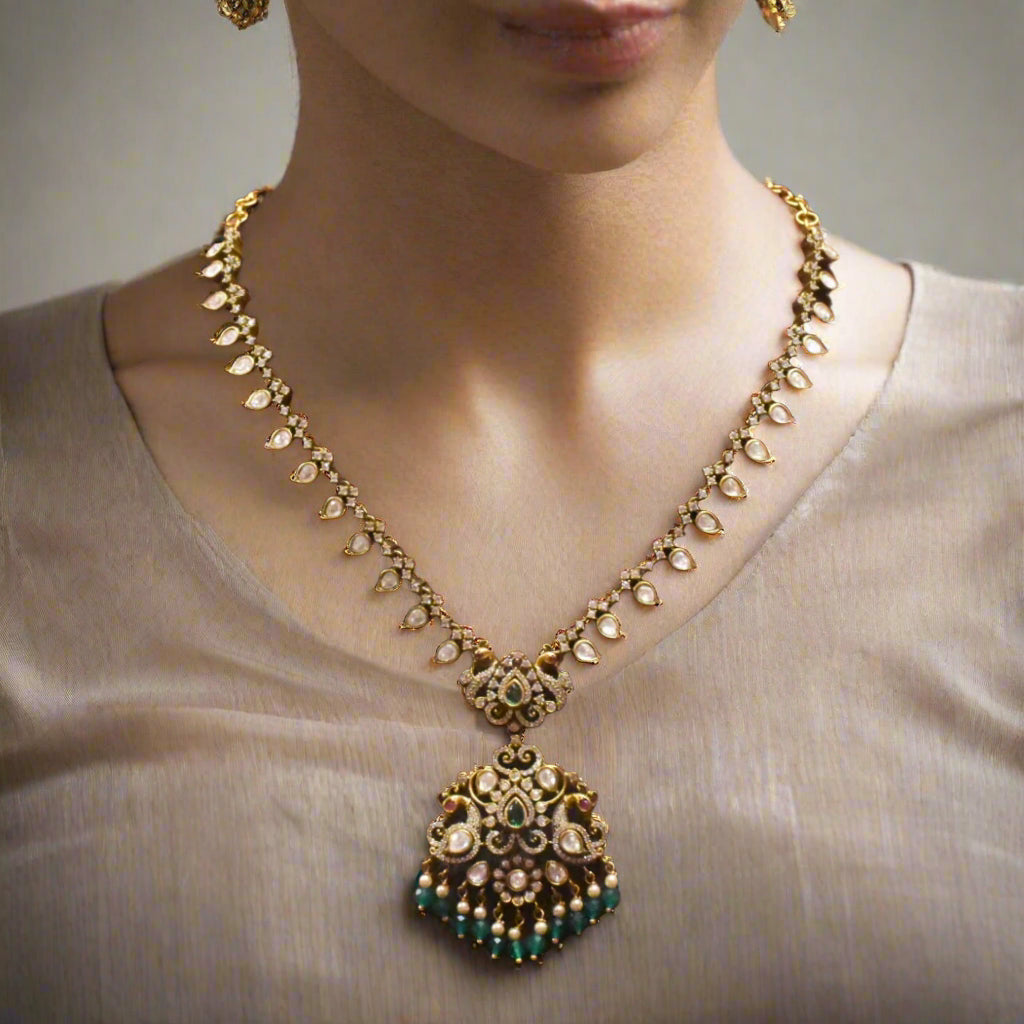 Decorative necklace with a pendant on a brown mannequin bust.