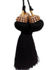 Black tassel with gold and red embellishments on a white background