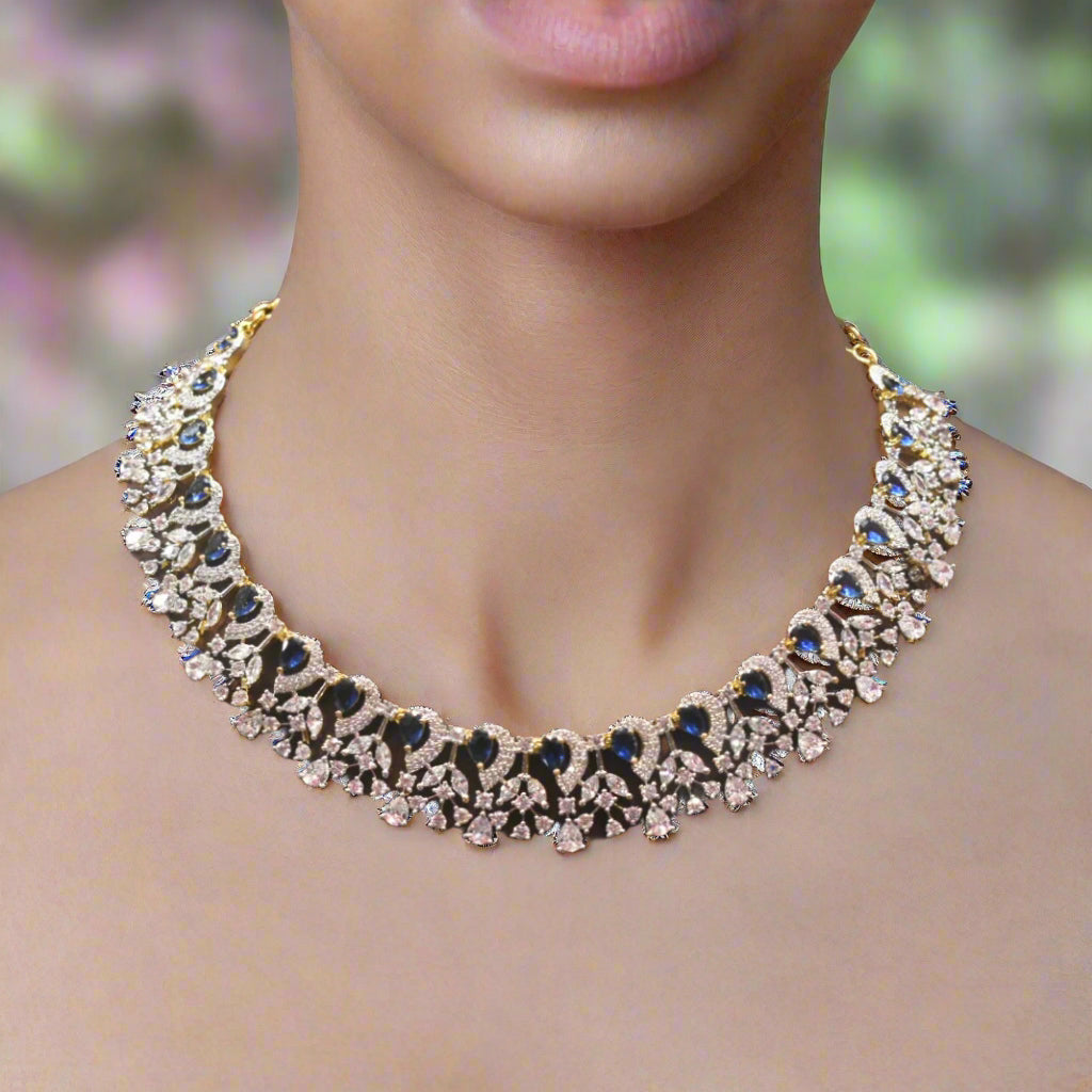 Elegant necklace with blue and clear stones on a blurred background