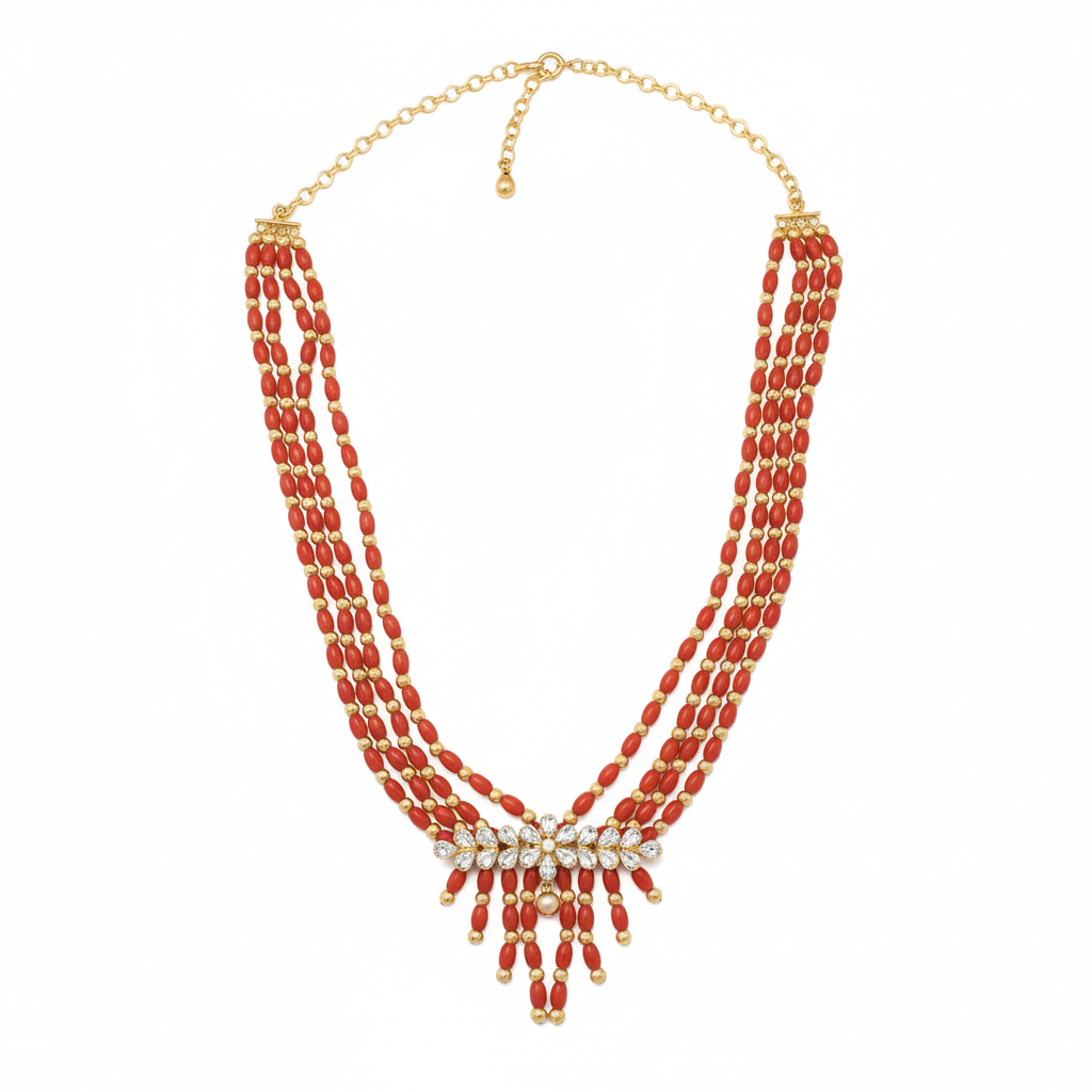 Coral red multi-strand beaded necklace with crystal centerpiece on white background
