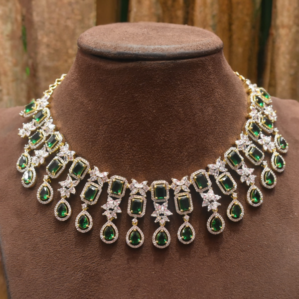 Green and white gemstone necklace on a brown velvet mannequin