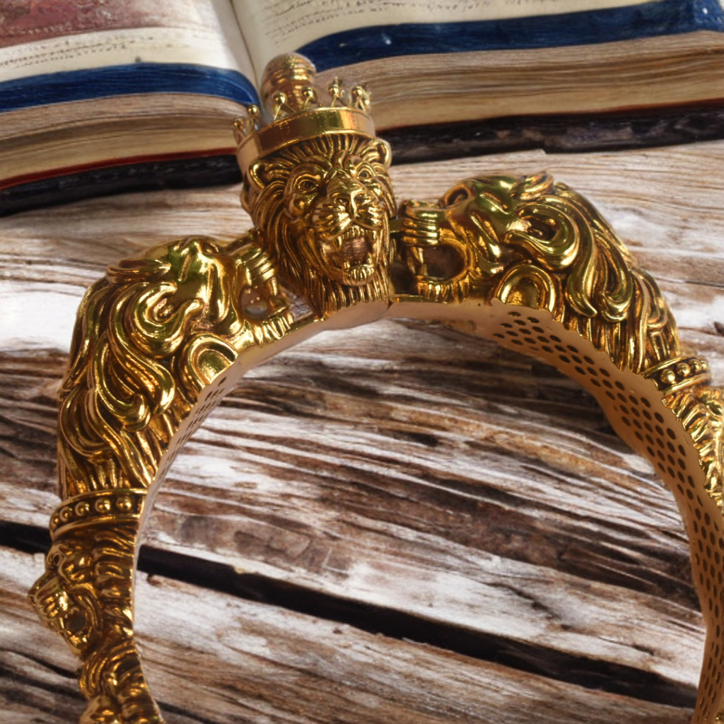 Gold bracelet with intricate design on a textured surface