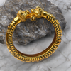 Gold bracelet with lion head design on a stone and marble background