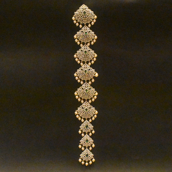 Decorative gold bracelet with intricate patterns on a black background