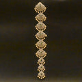 Decorative gold bracelet with intricate patterns on a black background