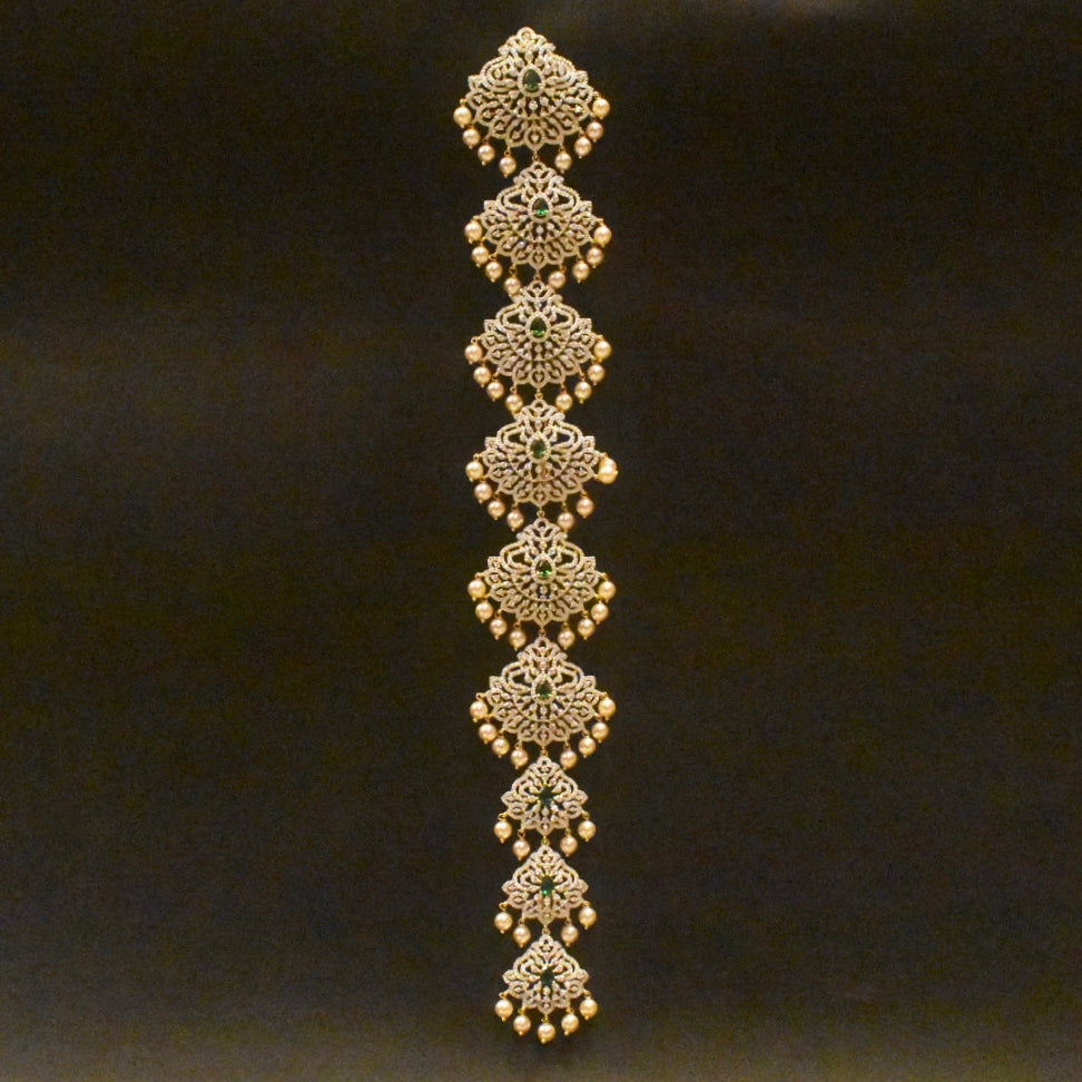 Decorative gold bracelet with intricate patterns on a black background