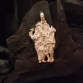 A silver locket featuring an image of Ganesh and Karthikeyan on a dark, textured background.