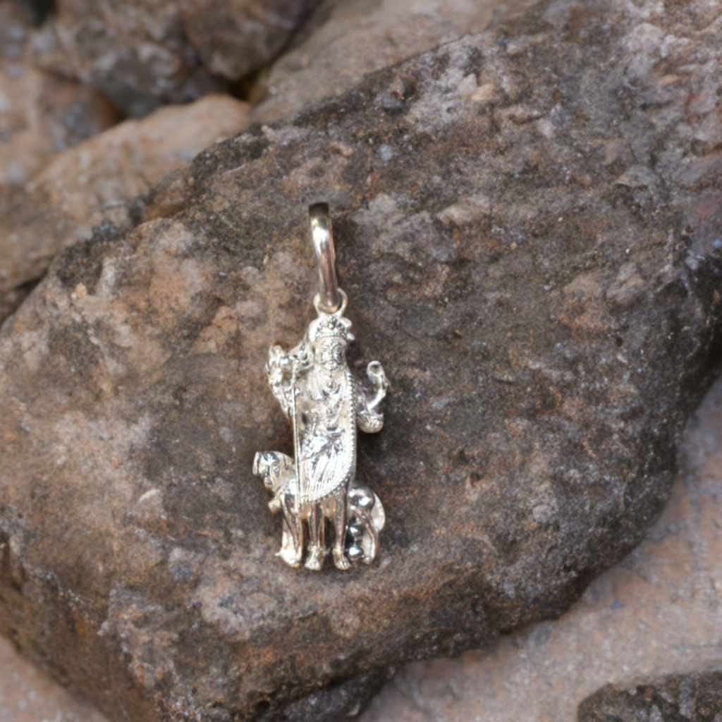 Silver pendant on a rocky surface