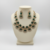 Emerald green gemstone jewelry set on mannequin display