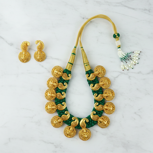 Flat lay antique gold Lakshmi kasu necklace set with green dori