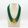 Green beaded necklace on mannequin