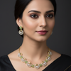 Model wearing green necklace set with earrings
