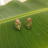 Handmade Emerald Peacock Stud Earrings banana leaf flat lay