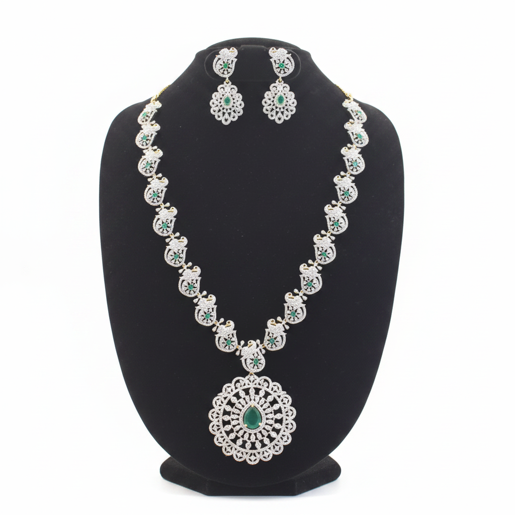 Emerald and diamond peacock motif necklace set with matching earrings on white background