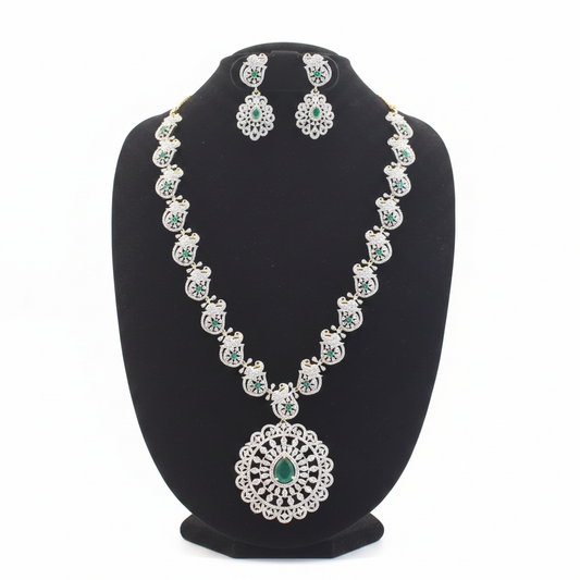 Emerald and diamond peacock motif necklace set with matching earrings on white background