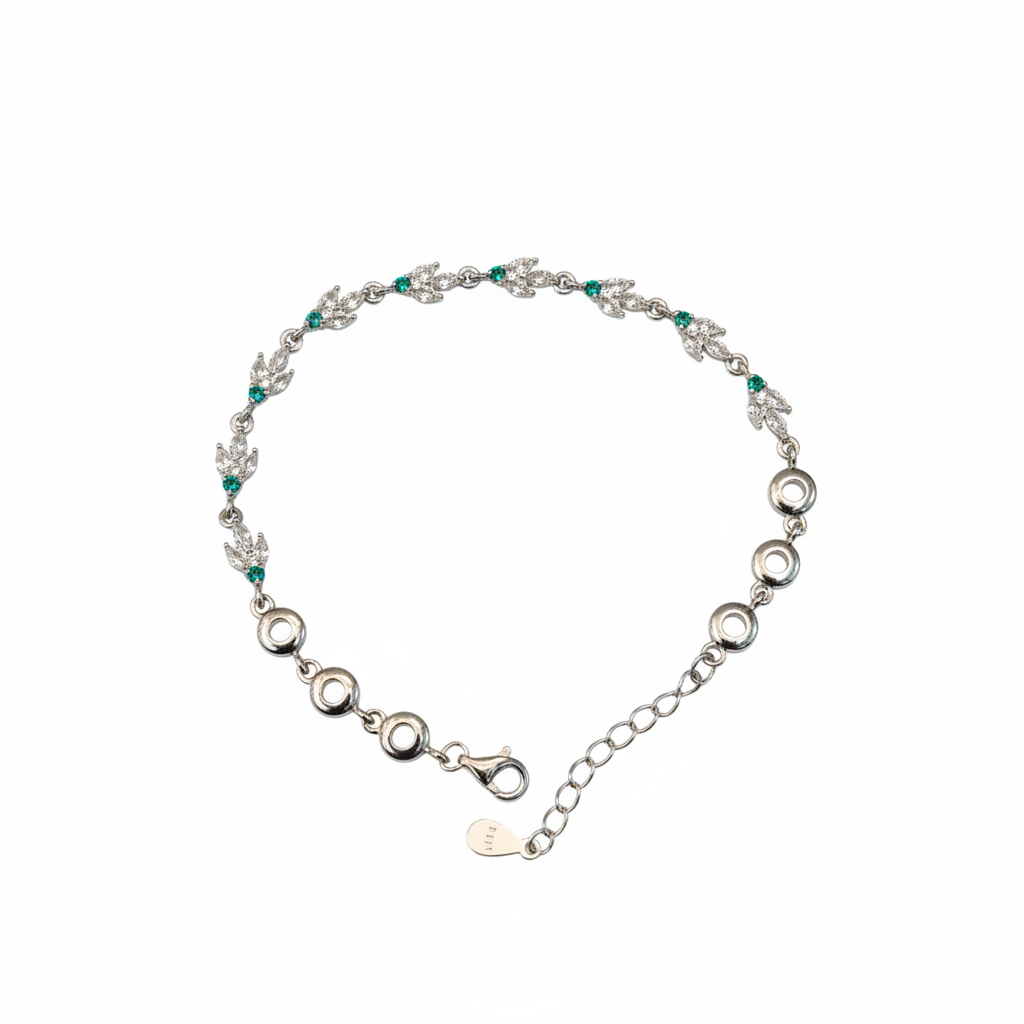 925 sterling silver bracelet with leaf motifs and green gemstones on white background