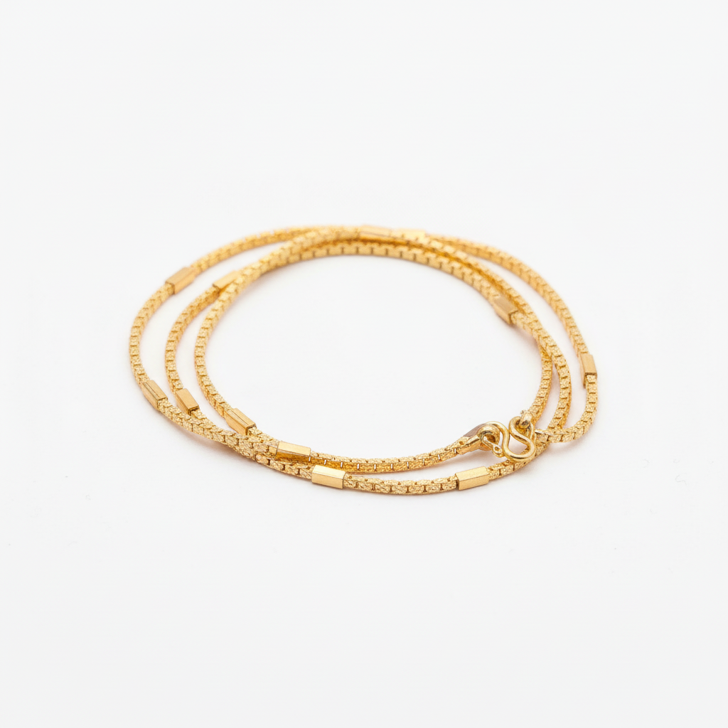 24K gold plated ornate one gram chain on white background