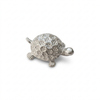 Silver-tone turtle figurine with a patterned domed shell on a white background