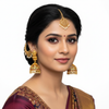 Model wearing Goddess Laxmi Nagas Antique Kemp Jhumka Earrings on white background - lifestyle photo