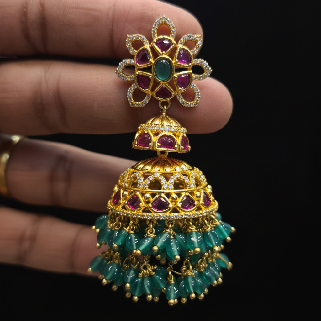 Kempu Emerald Jhumka close-up detail showing ruby kempu stones, emerald green beads and gold filigree