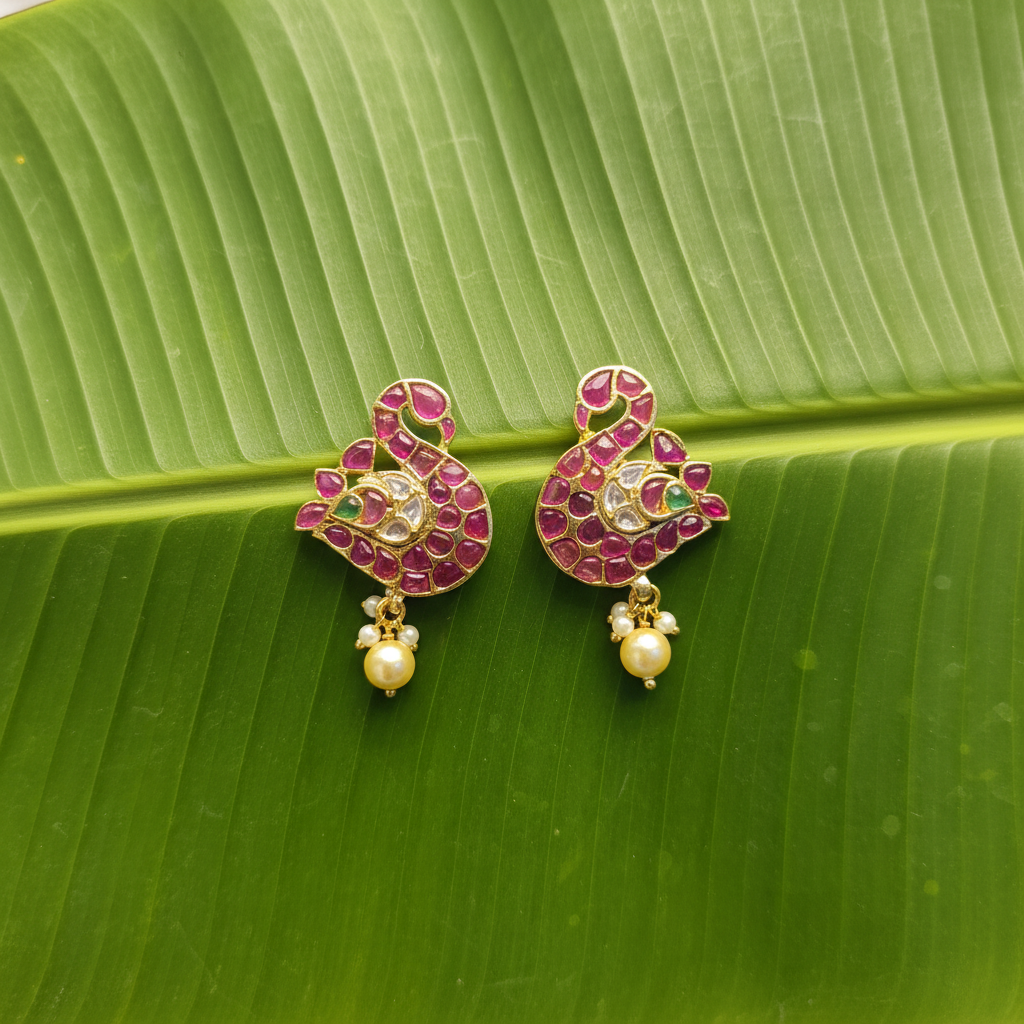 Handmade Kempu Duck Swan Earrings on banana leaf flat lay