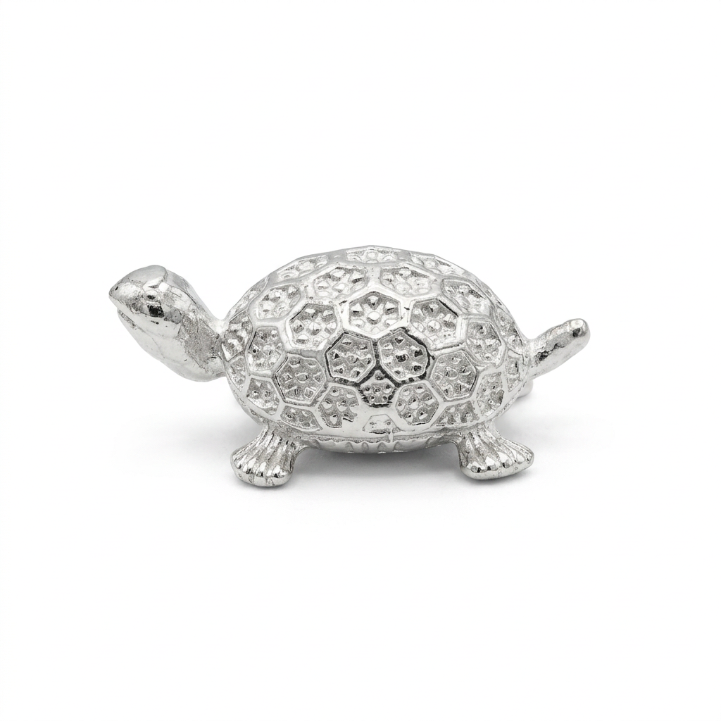 Silver turtle idol, side view on white background