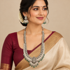 Model wearing an oxidized Lakshmi long haram necklace and matching jhumka earrings