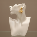 Gold temple jhumka earrings displayed on mannequin