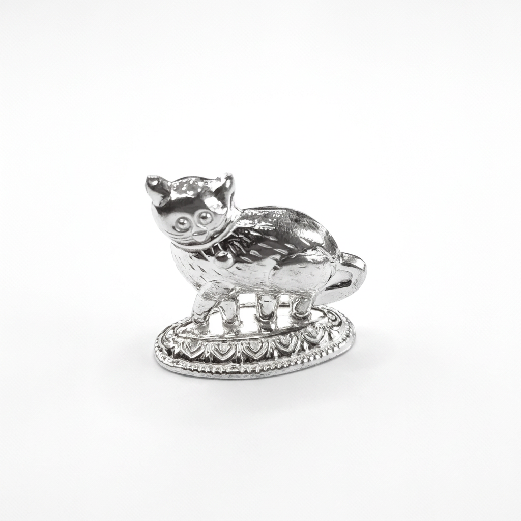 Silver cat idol on a decorative oval base against a white background