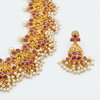 Close-up of Kempu Guttapusalu motifs and white bead clusters