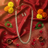 Gold diamond leaf necklace set flat lay with Indian cultural props