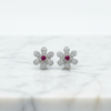 Victorian Ruby Flower Stud Earrings on white marble background