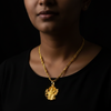 Narasimha Swami pendant worn on neck with gold chain – lifestyle editorial photo