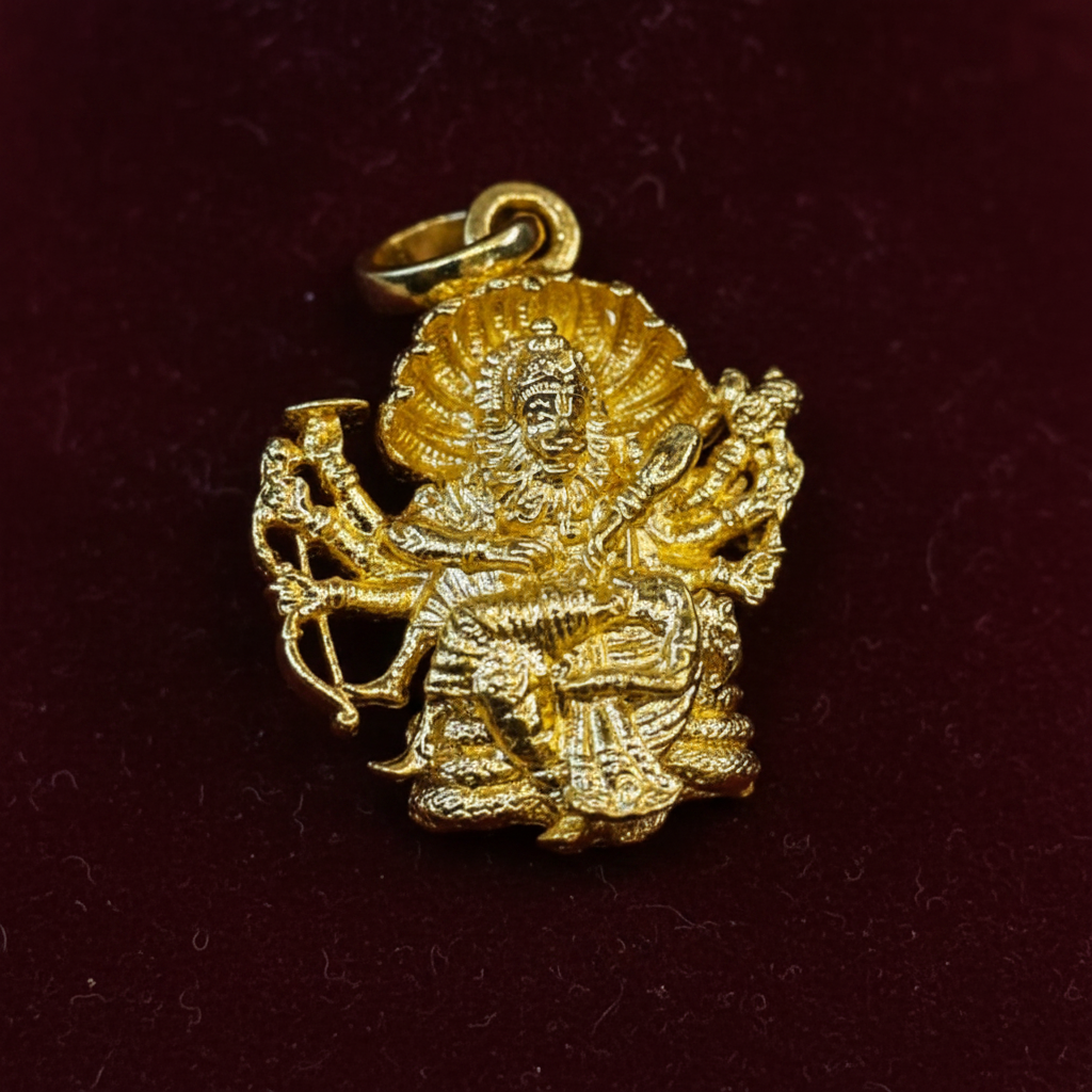 Close-up macro of Narasimha Swami gold pendant showing intricate carving detail