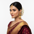 Model wearing Goddess Laxmi Matte Gold Temple Jhumka Earrings on white background - lifestyle photo