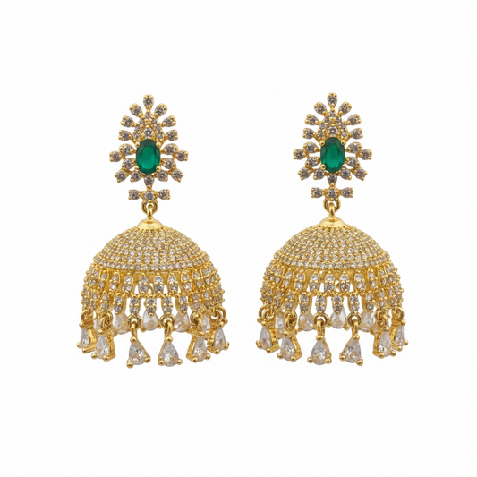 Gold plated CZ jhumka earrings with emerald green centre stone on white background